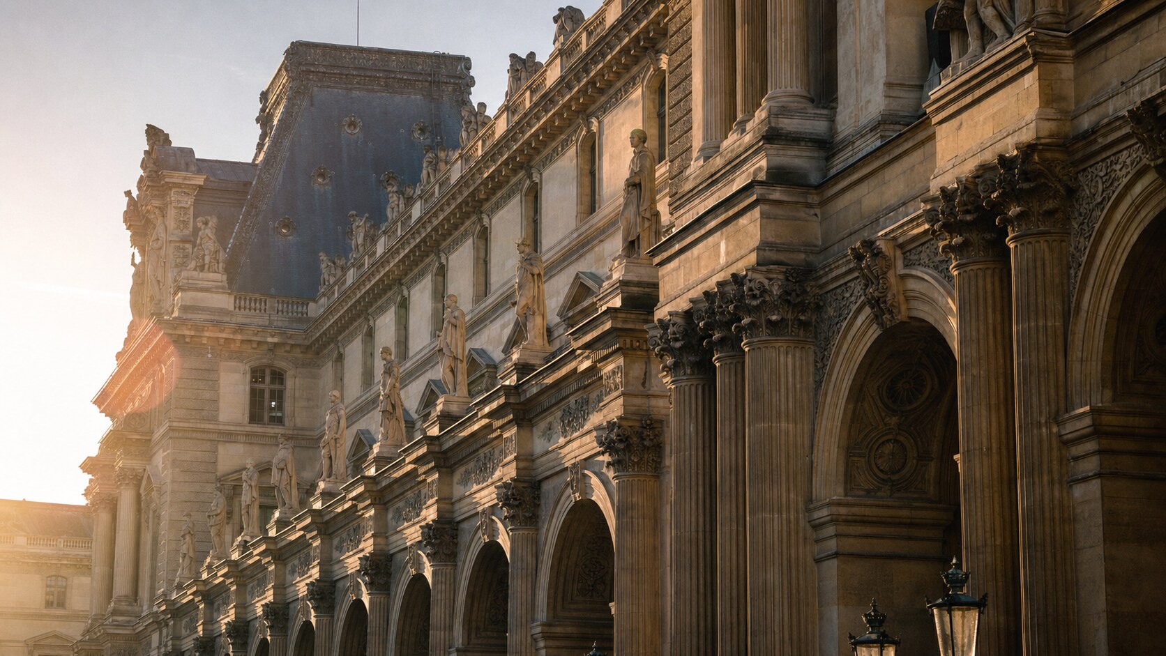 Close-up architectural detail of The Louvre at late afternoon, showing surface texture and material under directional sun