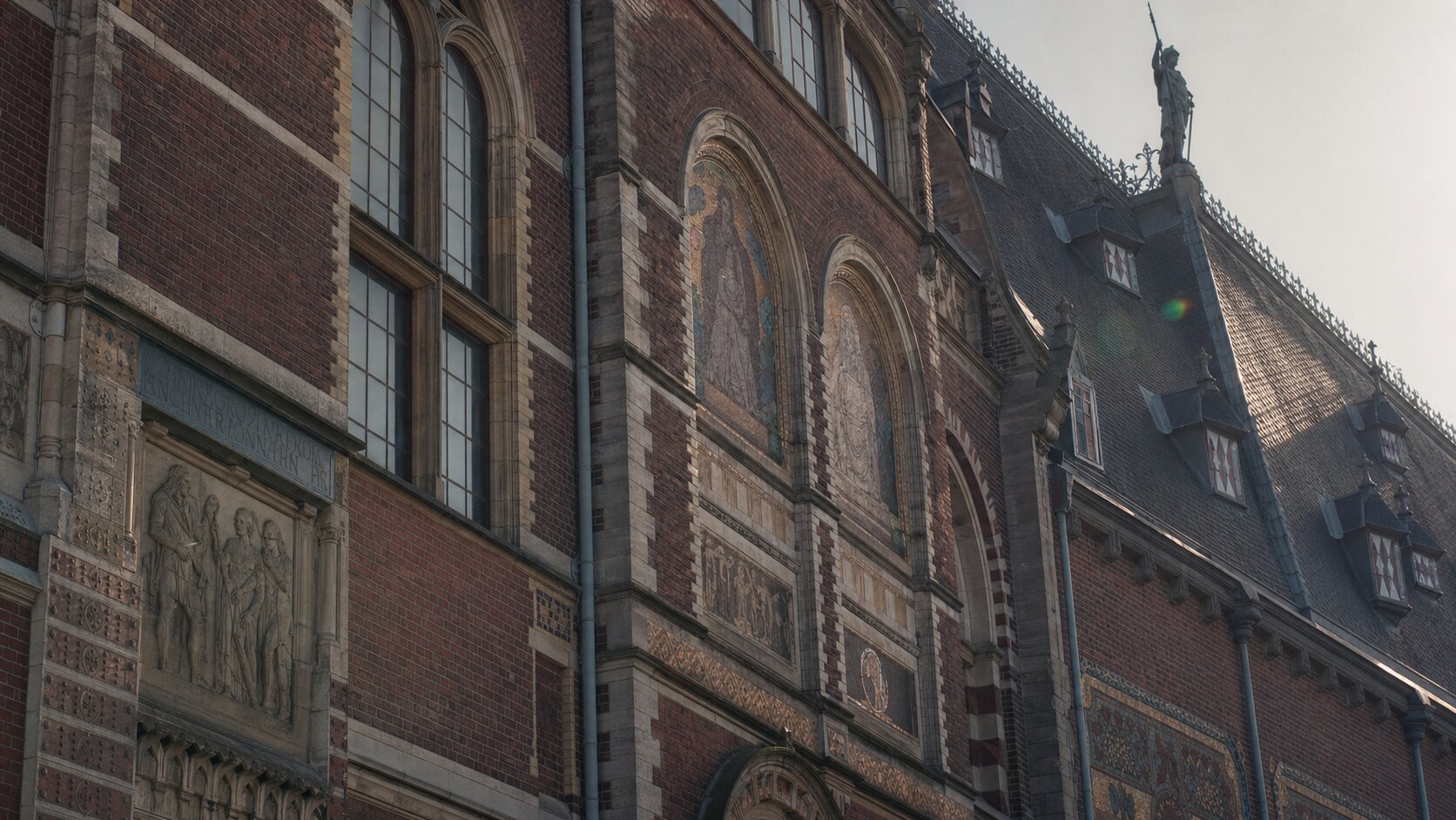 Close-up architectural detail of The Rijksmuseum at late afternoon, showing surface texture and material under directional sun