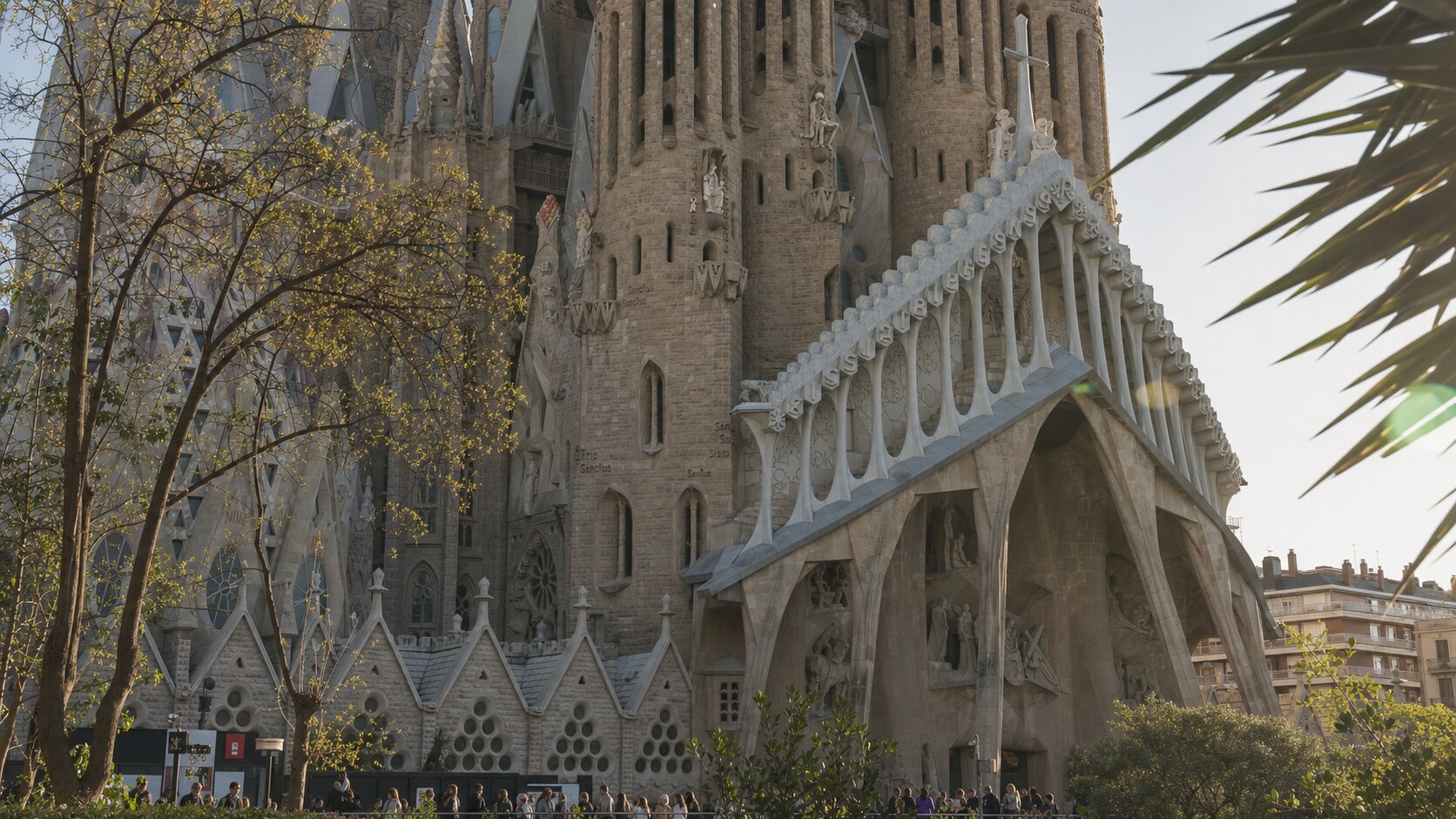 Close-up architectural detail of The Sagrada Familia at late afternoon, showing surface texture and material under directional sun
