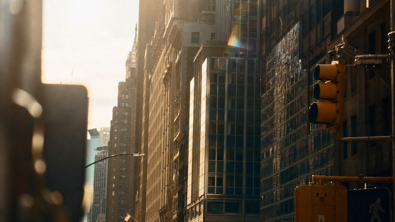 Close-up architectural detail of Times Square at late afternoon, showing surface texture and material under directional sun