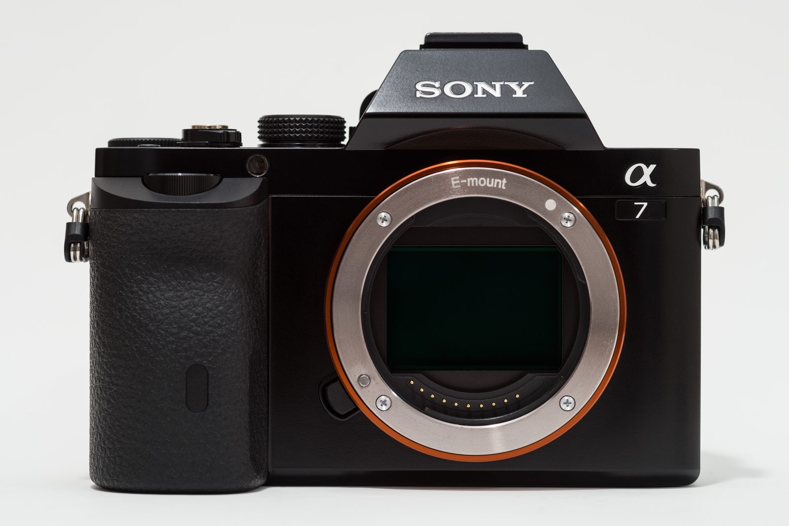 Retro mirrorless camera on a cafe table, ideal for discreet street photography in urban settings.