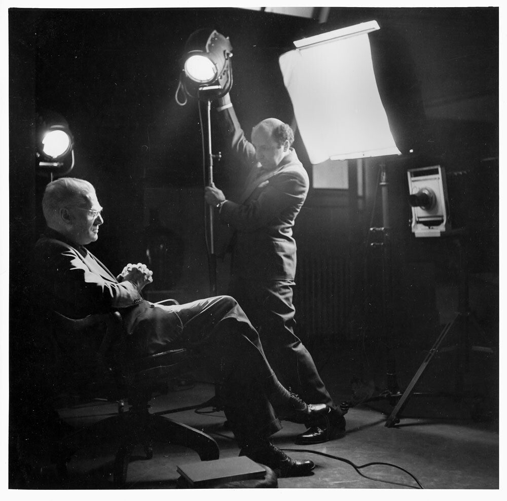 A professional studio lighting setup with a softbox and reflector.