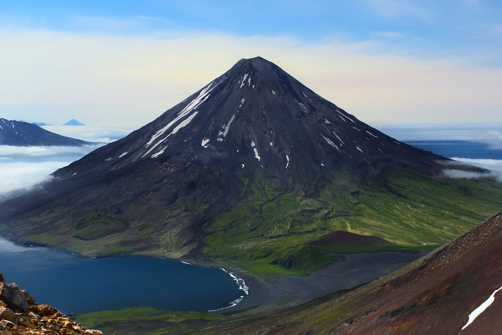 Professional workstation with photo software editing a landscape from the newest camera releases.
