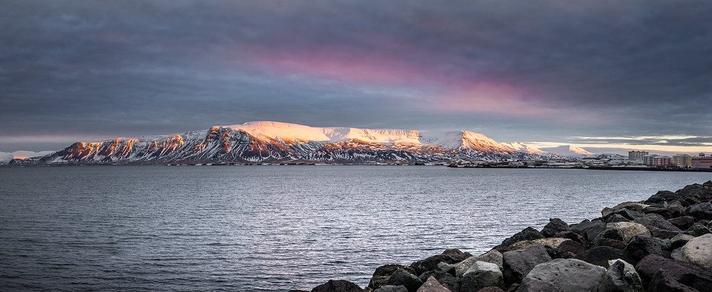 Close-up of hands editing a stunning landscape photograph on a high-end digital tablet with professional software.
