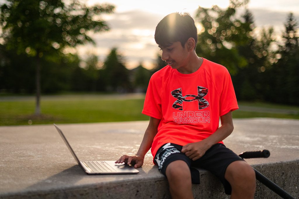 Photographer reviewing their portfolio on a tablet outdoors after saving time with an AI editing workflow.