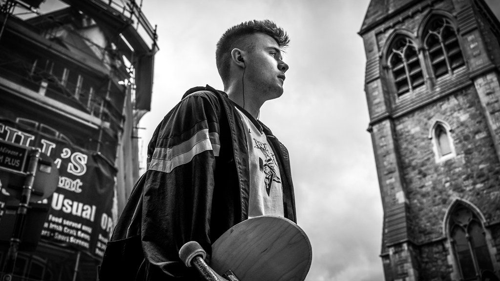 Videographer filming cinematic street footage using a Panasonic S1Hii camera on a motorized gimbal.