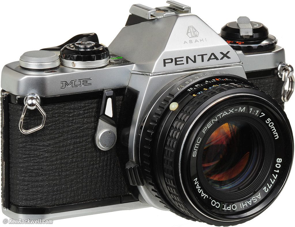 Hands adjusting camera dials to demonstrate how to use manual mode camera settings for professional photography.