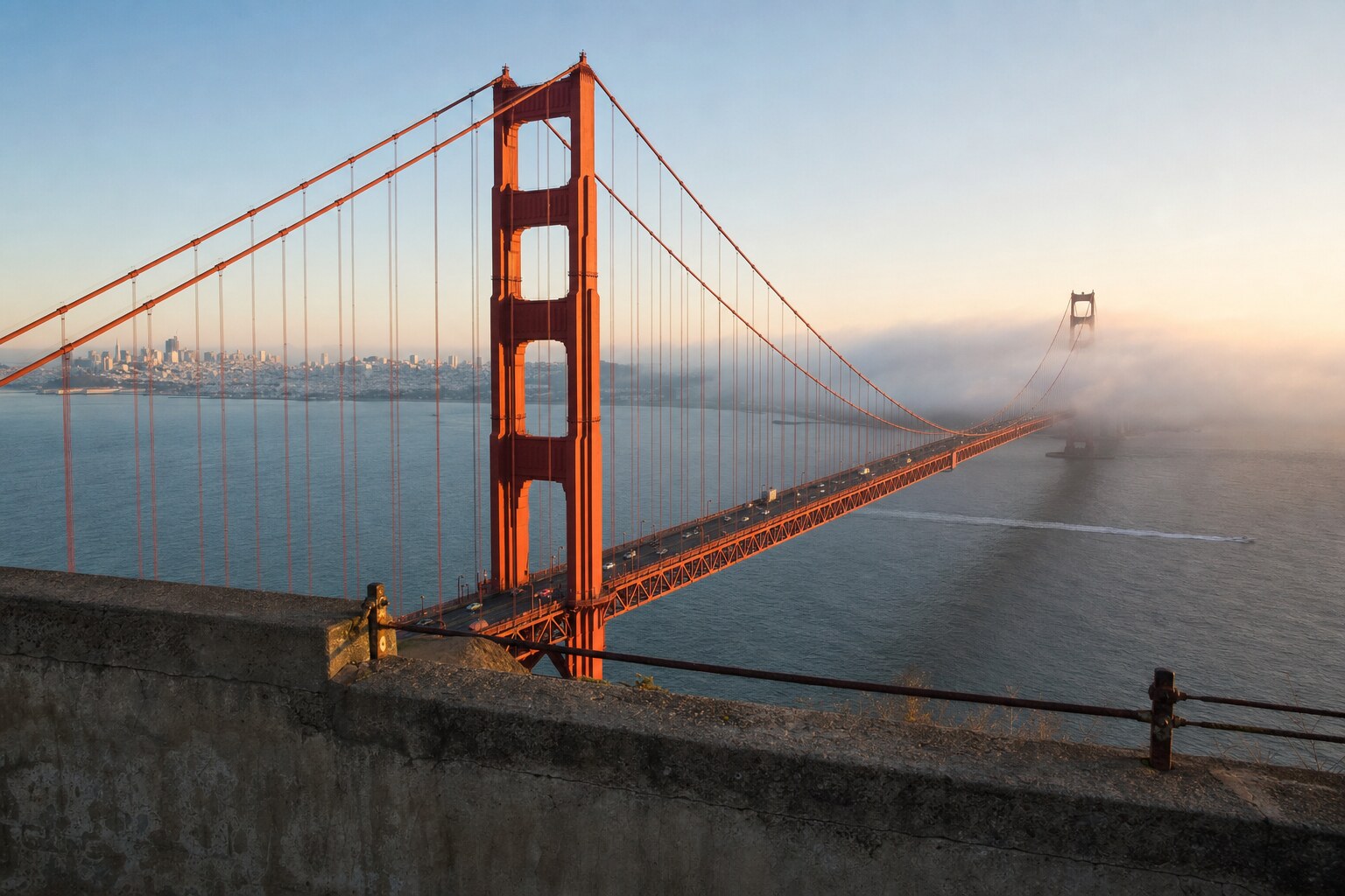 Golden Gate Bridge north tower above marine fog from Battery Spencer at sunrise