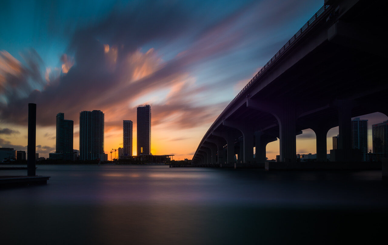 Miami skyline and a bridge in silhouette at sunset