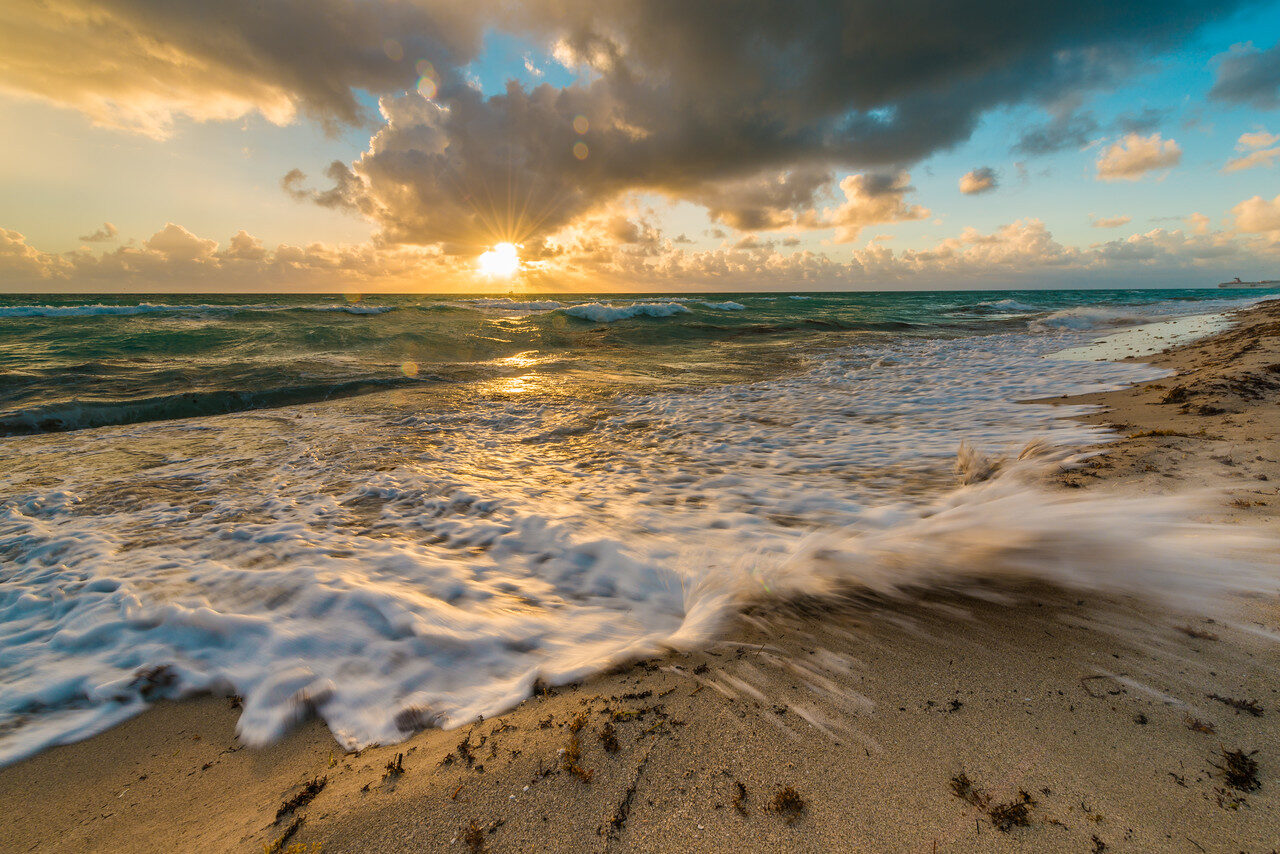 Waves catching warm sunlight on a Miami beach