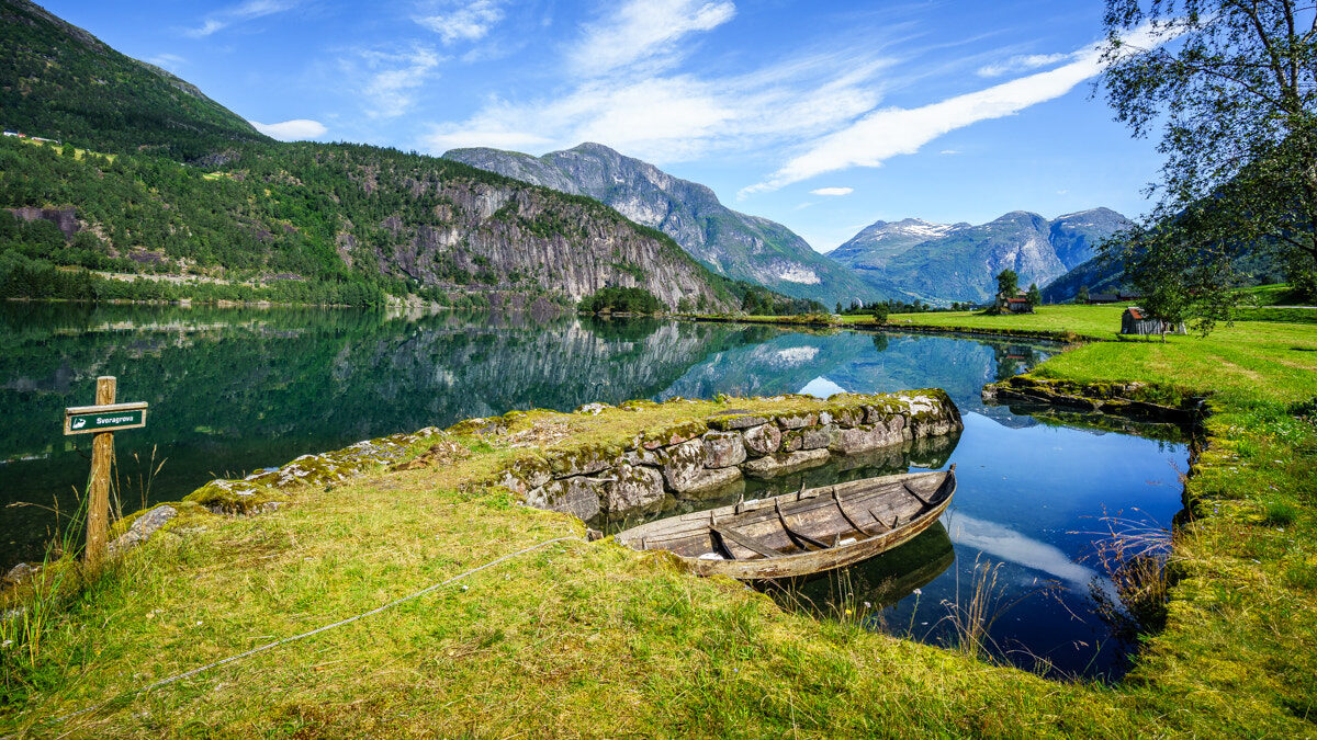 Fjord valley in Stryn, Norway, muted greens and greys under overcast sky — a quintessential Scandinavian travel landscape