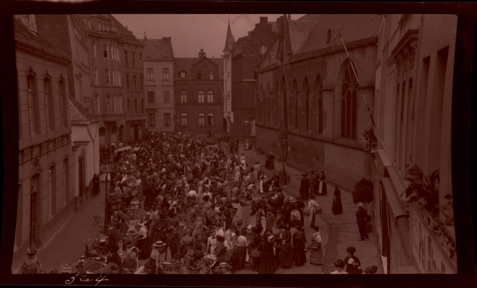 Outdoor street market stalls with hanging goods and pedestrians, classic documentary travel scene showing everyday commerce