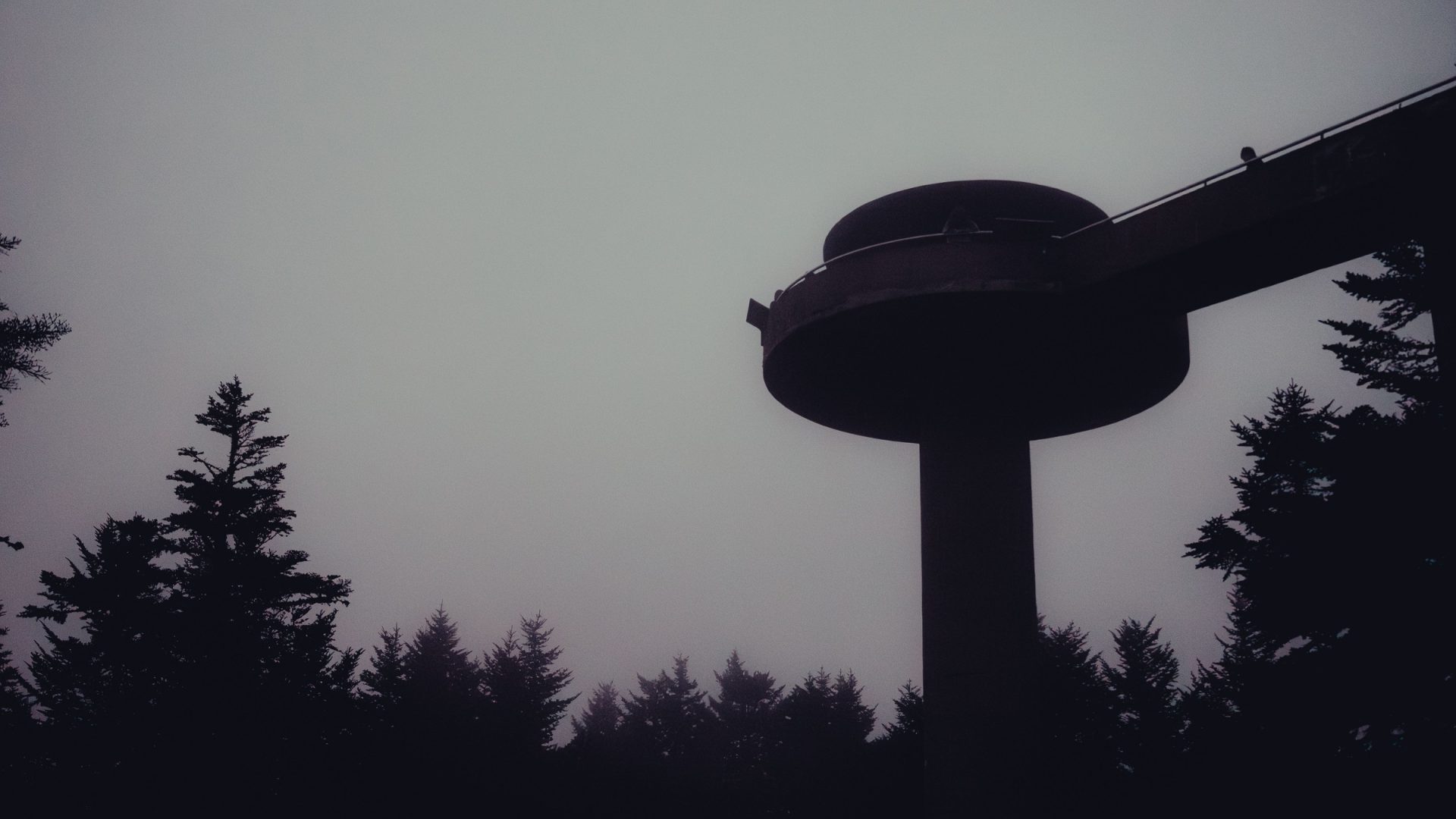Kuwohi observation tower and ramp silhouetted against fog