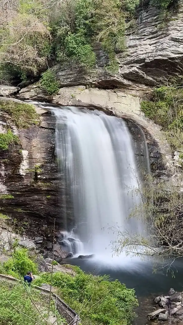 Long exposure of Looking Glass Falls in Pisgah National Forest, North Carolina demonstrating a travel photography composition.