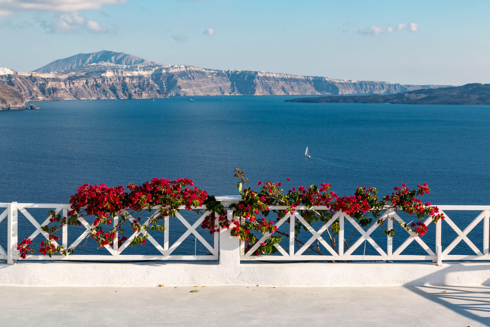 Oia village in Santorini Greece at twilight with whitewashed buildings blue domes and warm sunset glow on Aegean