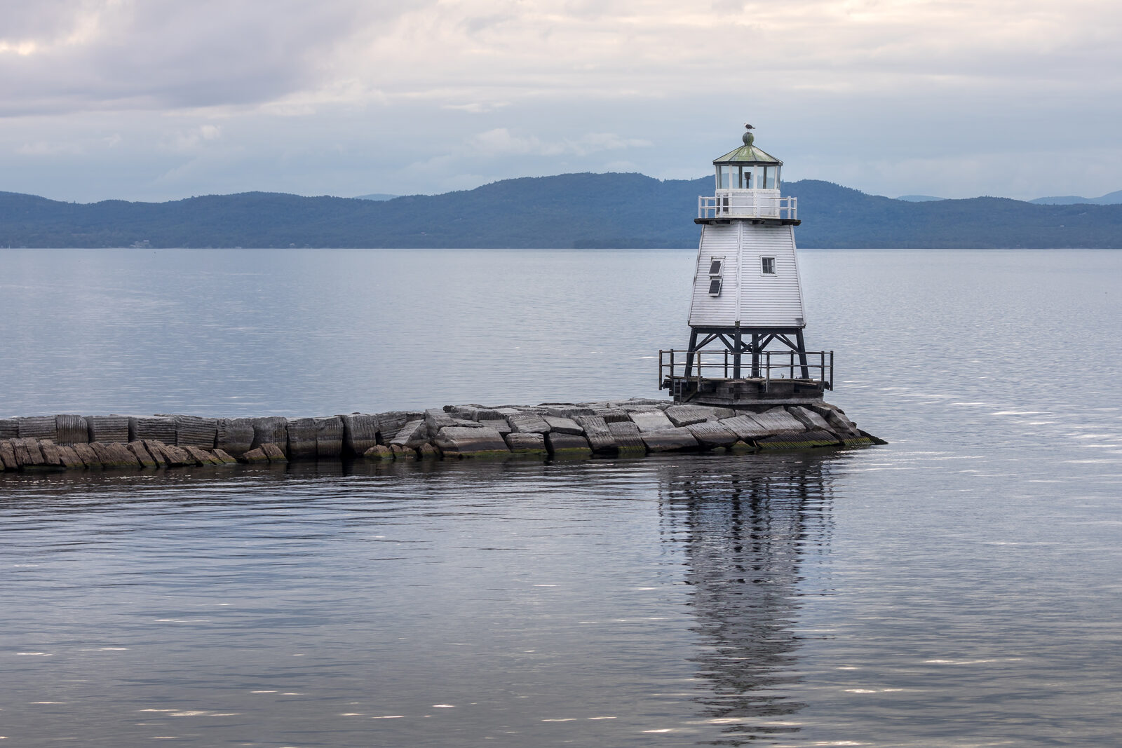 Harbor light at Burlington Vermont breakwater on Lake Champlain demonstrating a travel photography composition.
