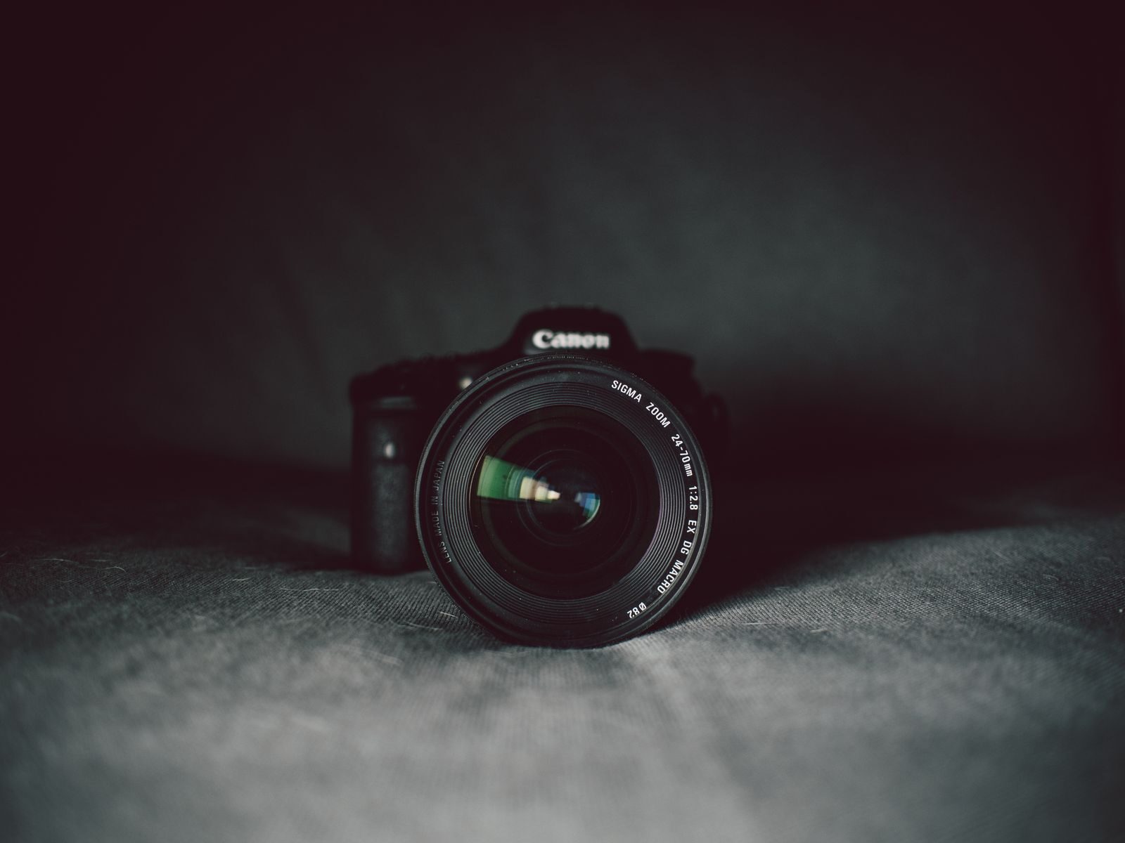 Telephoto lens on mirrorless body demonstrating system weight comparison for a Fuji X-H2S vs OM-1 II tutorial.