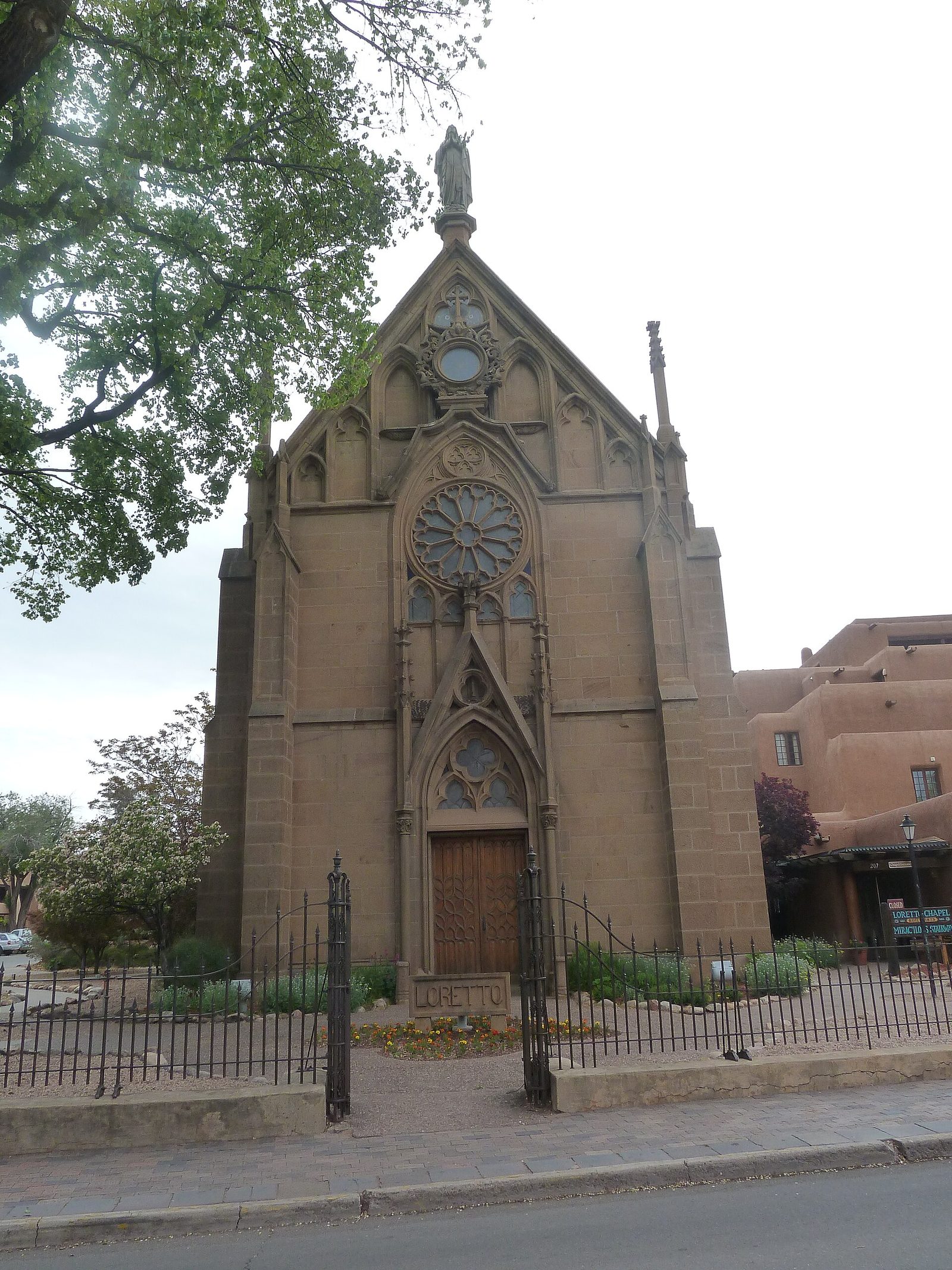 Stone facade of Loretto Chapel in Santa Fe, New Mexico demonstrating a travel photography composition.