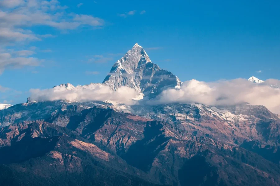 Snowcapped peak landscape of Machapuchare in the Annapurna Range, Nepal demonstrating a travel photography composition.