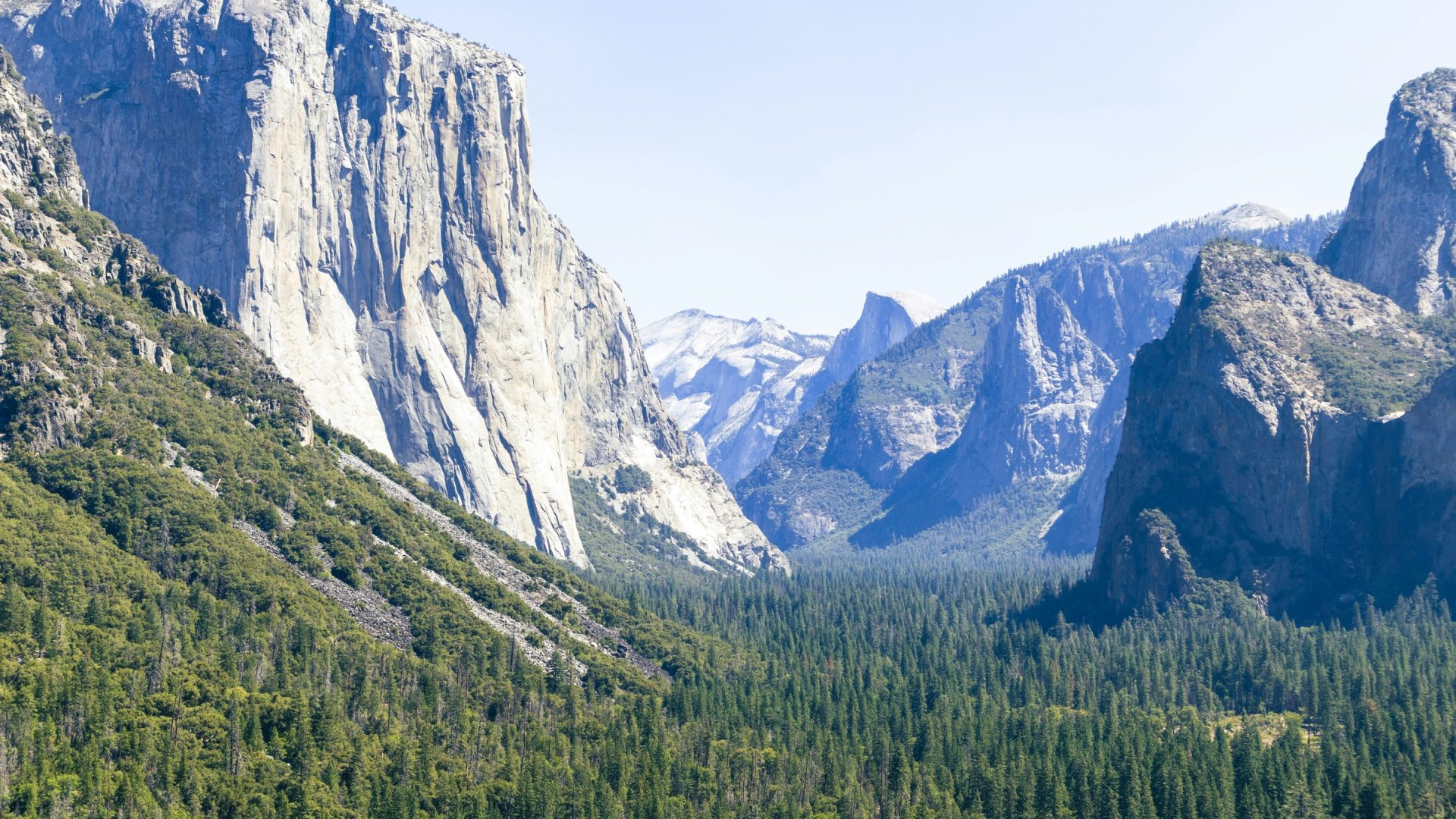 Sunlit El Capitan and distant Yosemite peaks at Tunnel View