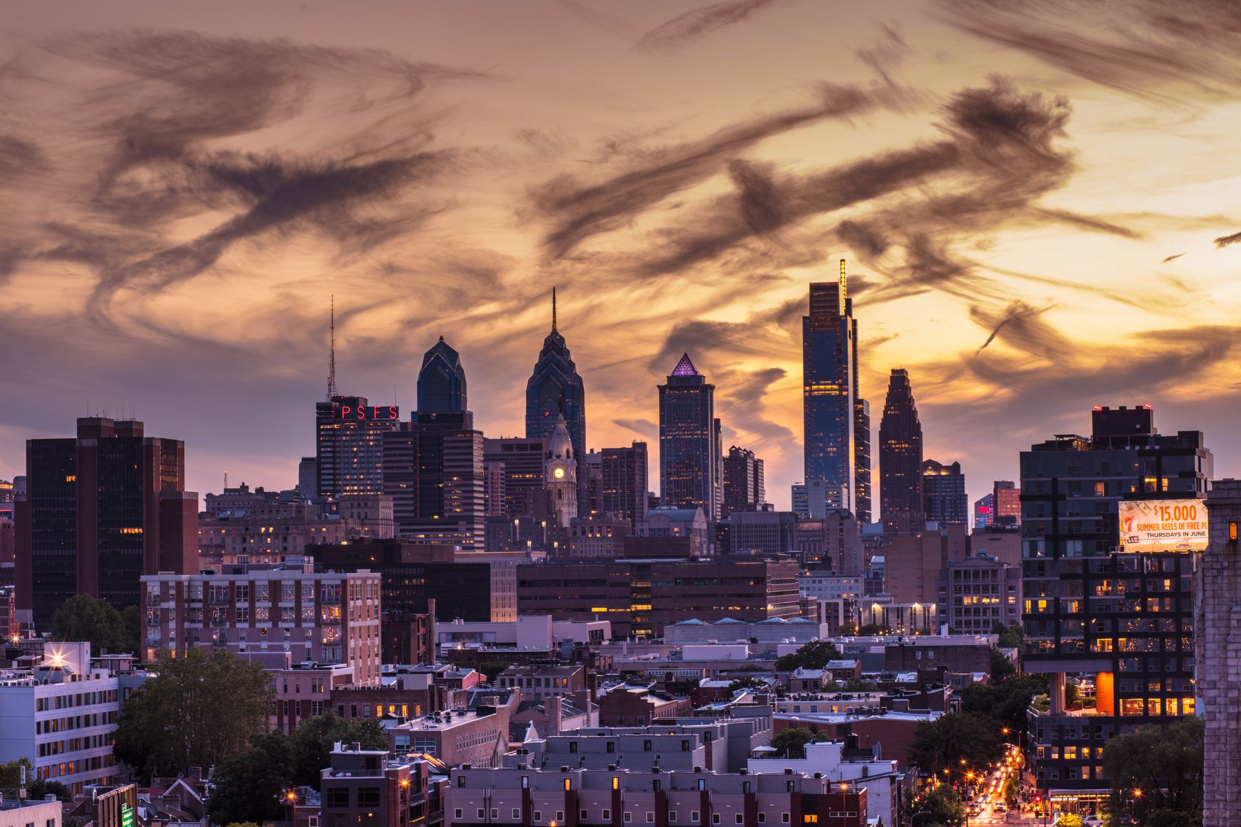 Philadelphia skyline under dramatic sunset clouds