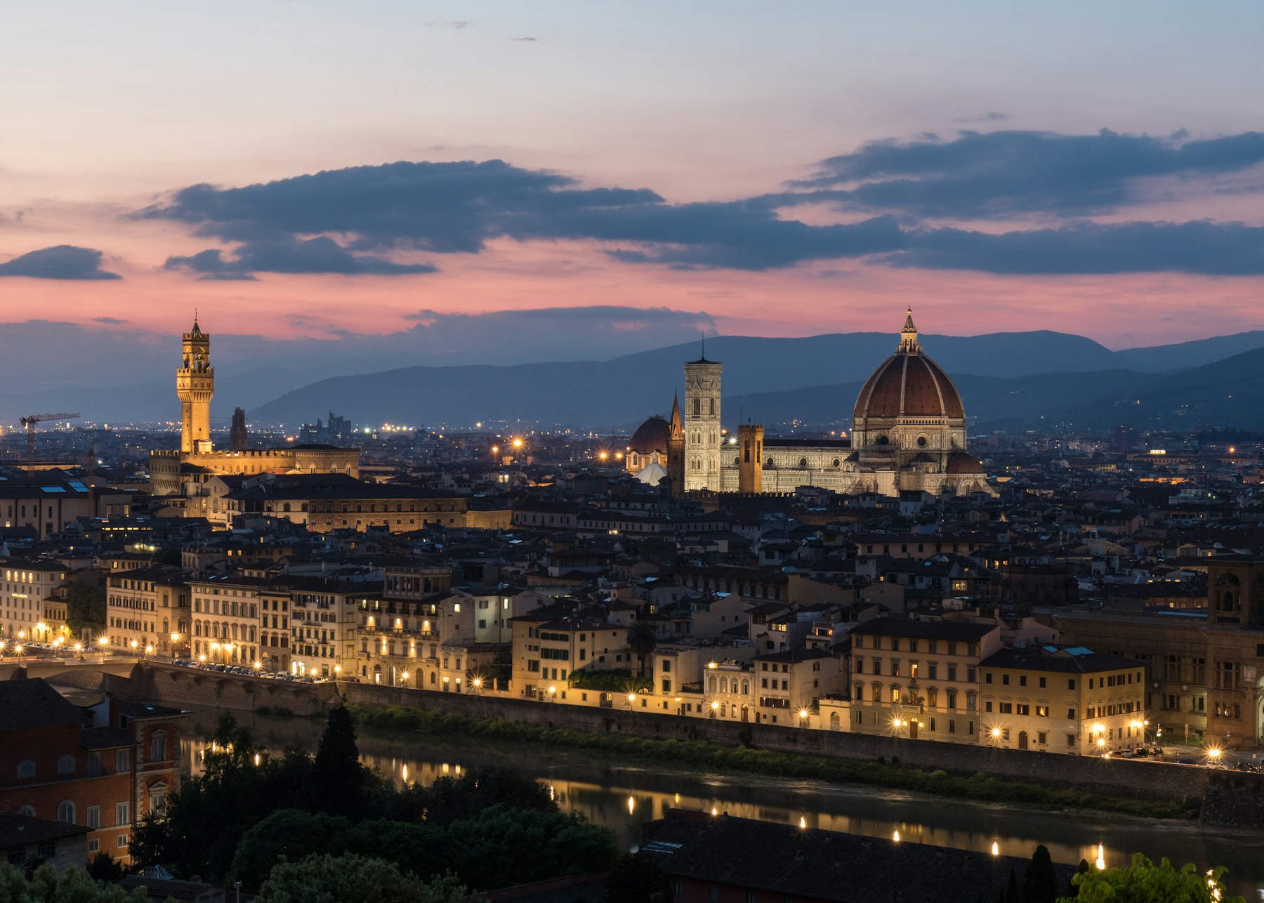 Florence Cathedral and Palazzo Vecchio above the Arno River at pink sunset