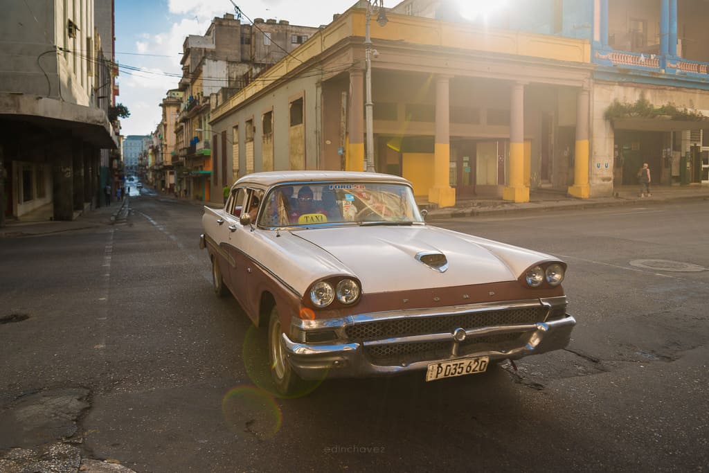 Vintage Ford taxi on a Havana street in warm backlight, Cuba, photographed by Edin Chavez
