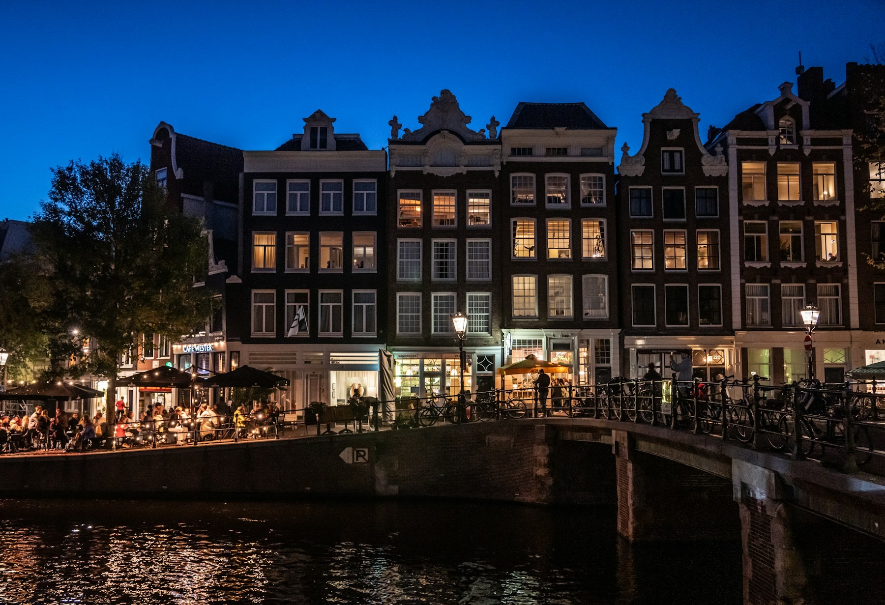 Amsterdam canal houses and bridge at blue hour