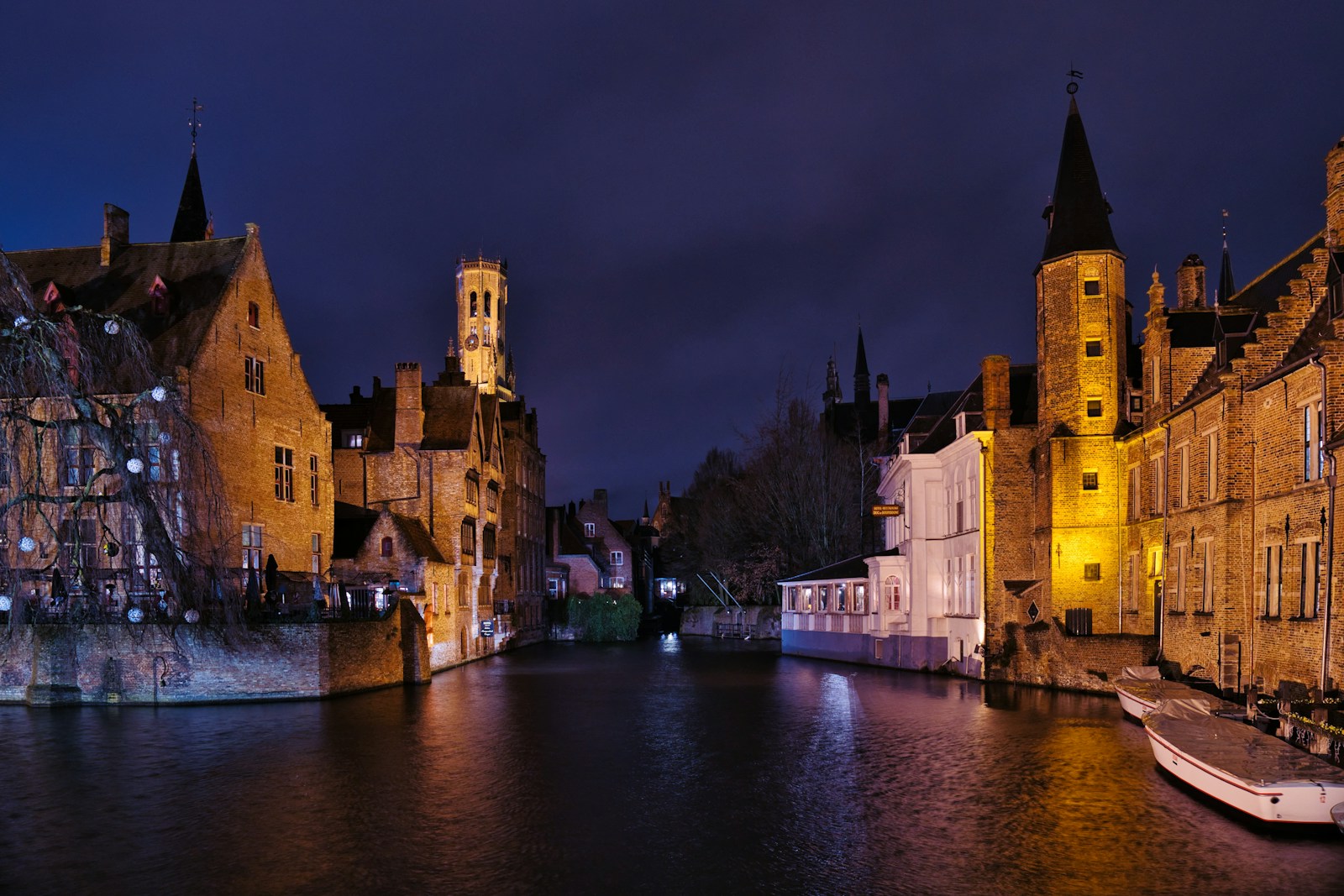 Rozenhoedkaai canal and Belfry of Bruges at blue hour