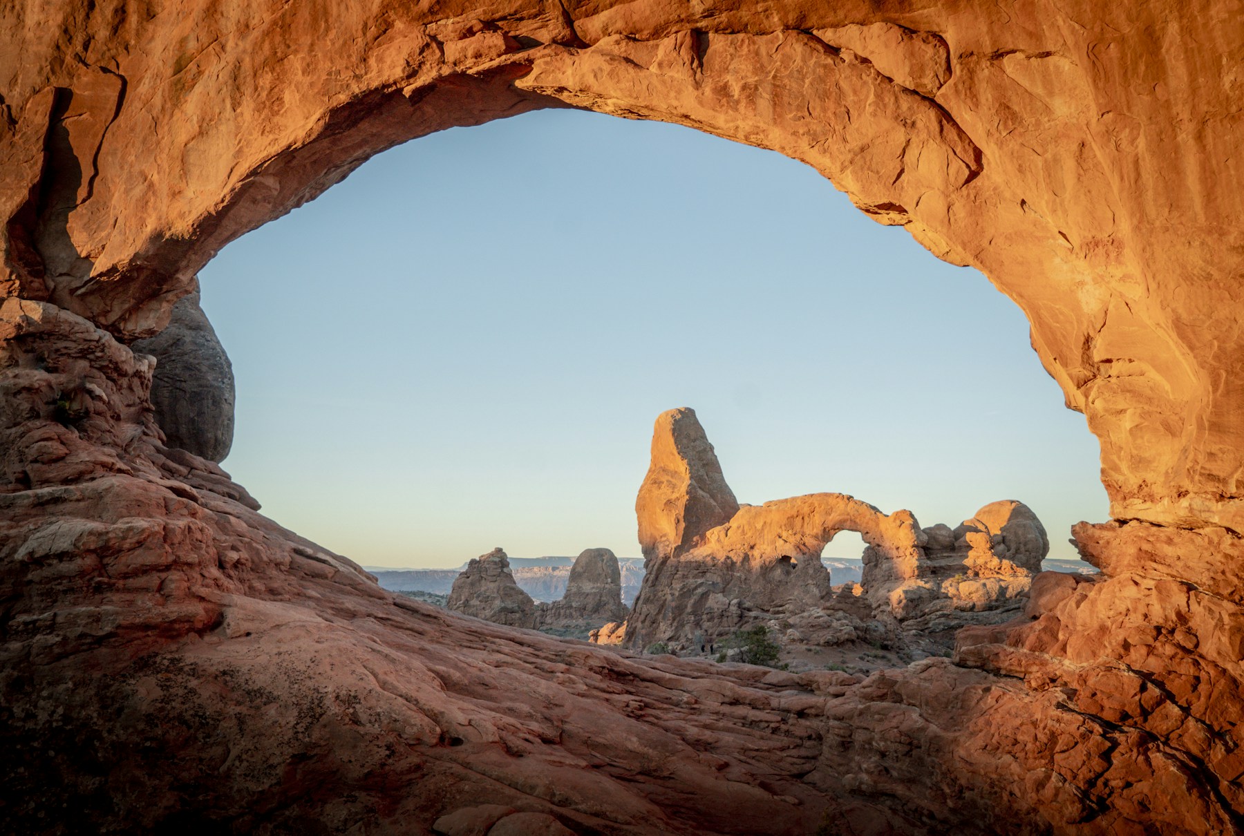 Turret Arch framed by the North Window in warm morning light at Arches National Park