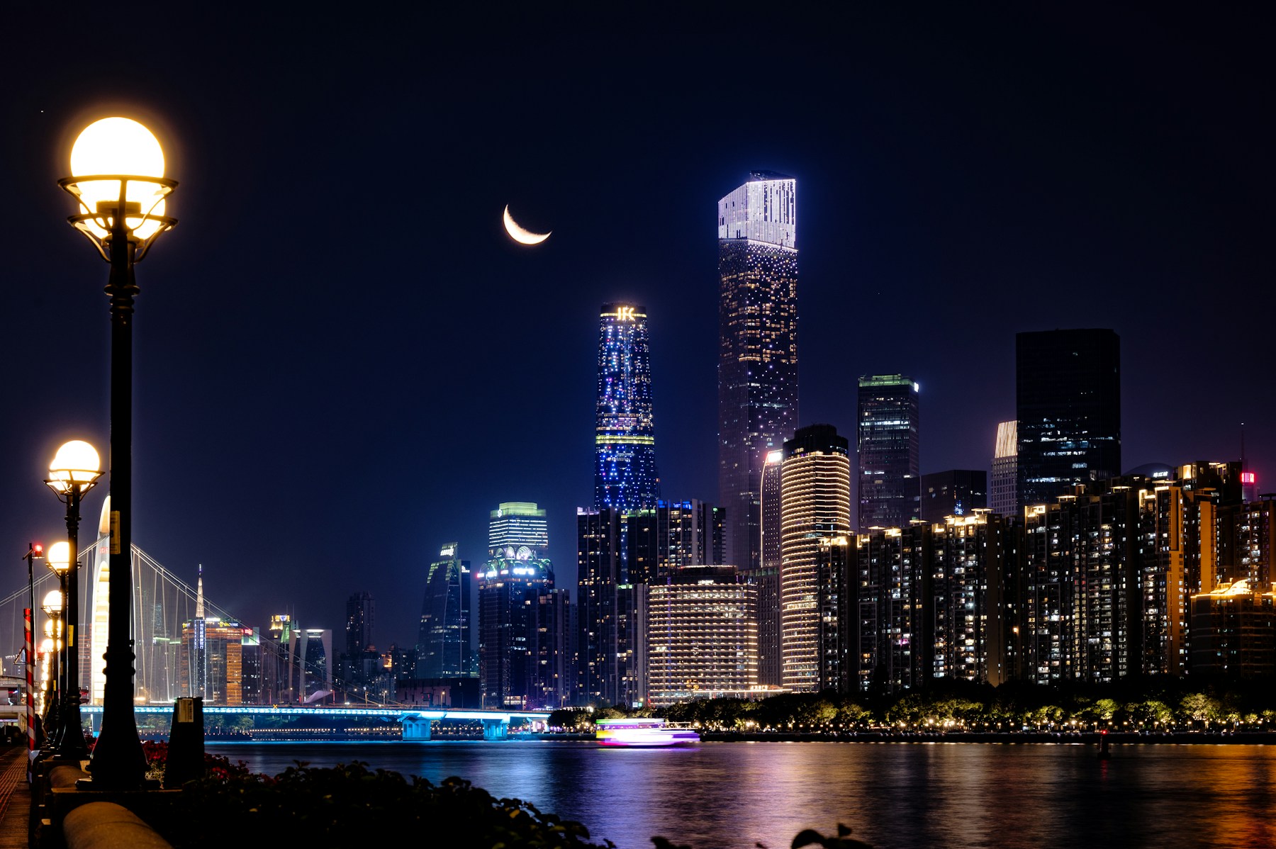 Pearl River and Zhujiang New Town skyline beneath crescent moon