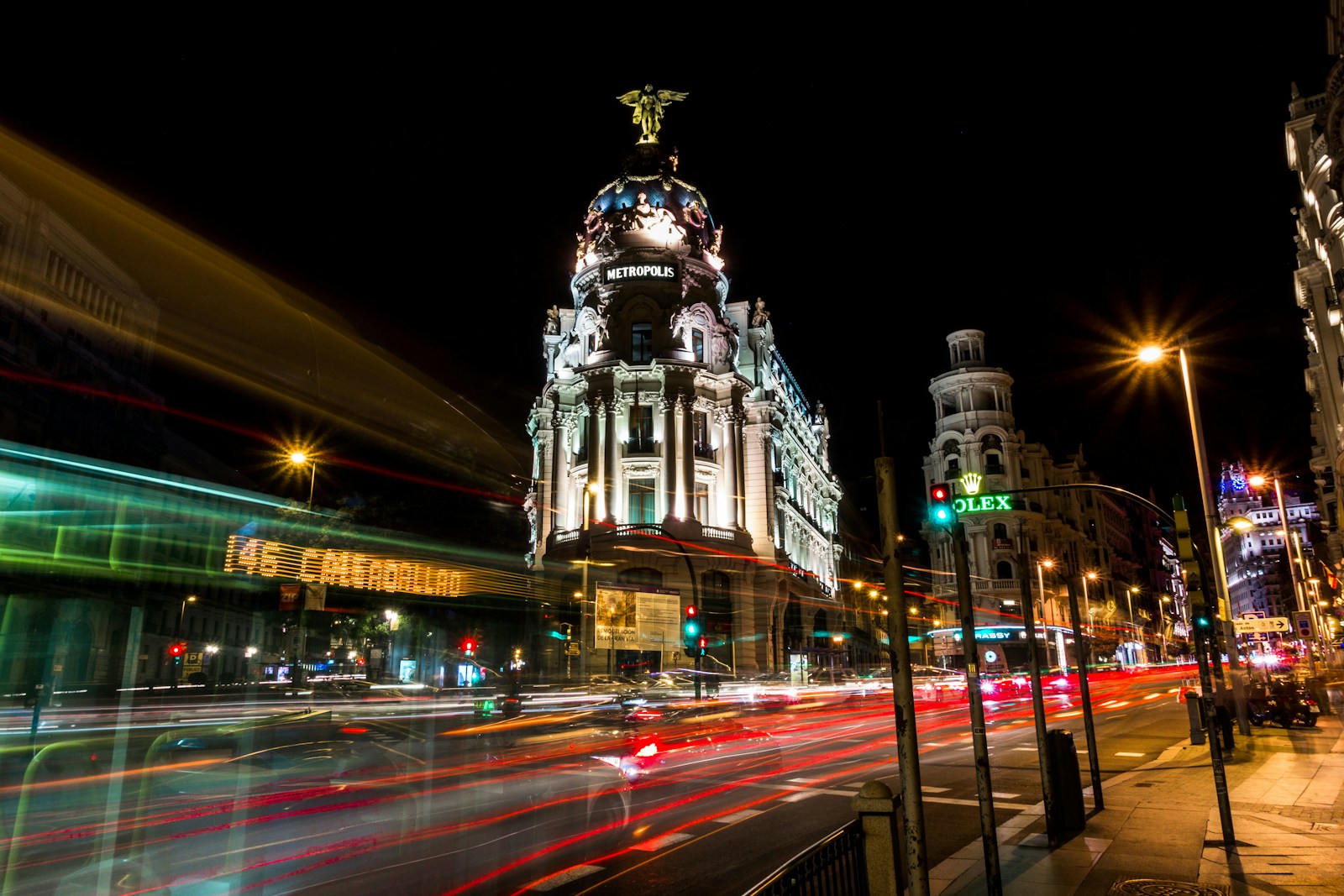 Metropolis Building and Gran Vía traffic light trails at night in Madrid
