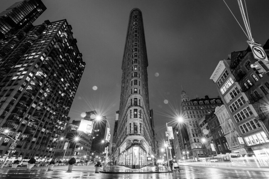 Black and white night photograph of the Flatiron Building in New York by Edin Chavez