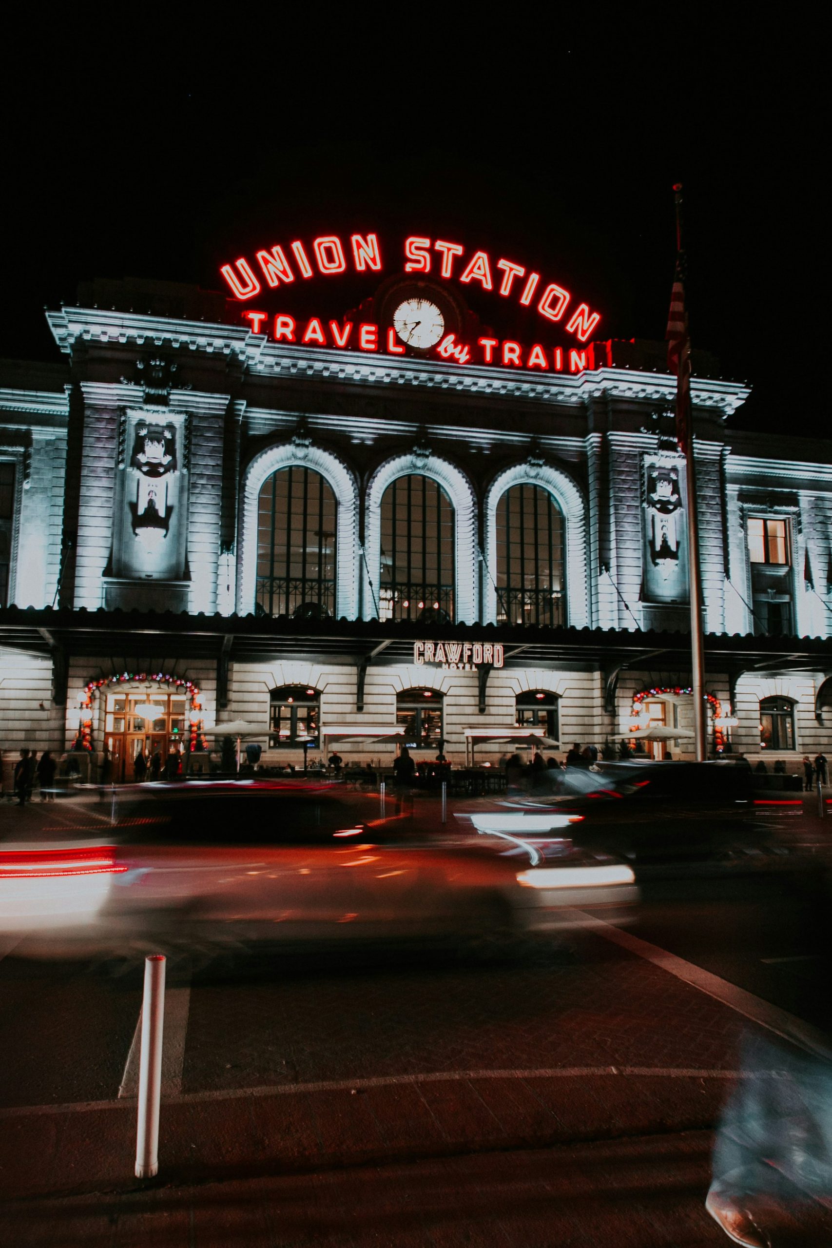 Denver Union Station at night with traffic light trails