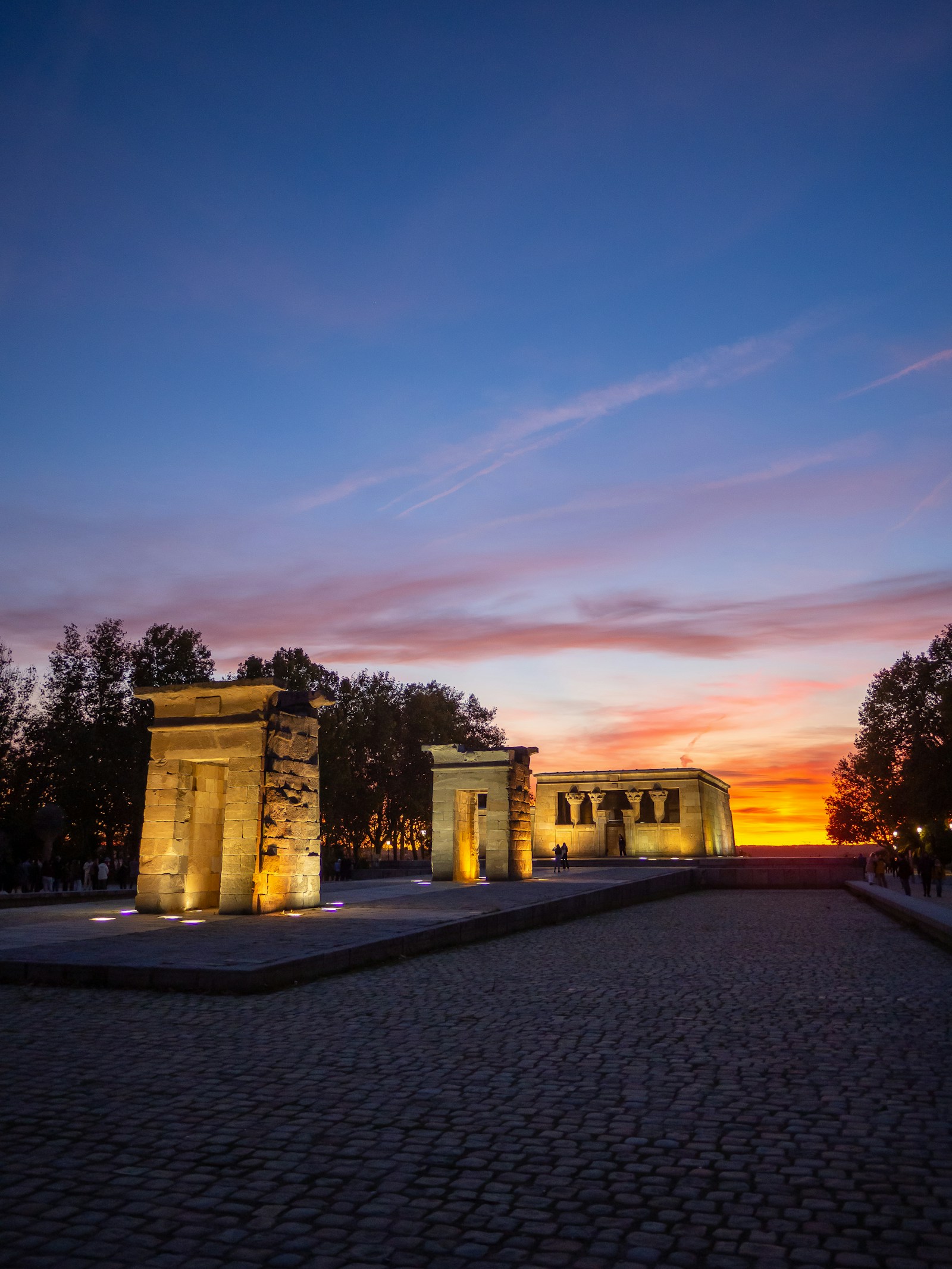 Temple of Debod illuminated beneath a pink and orange Madrid sunset