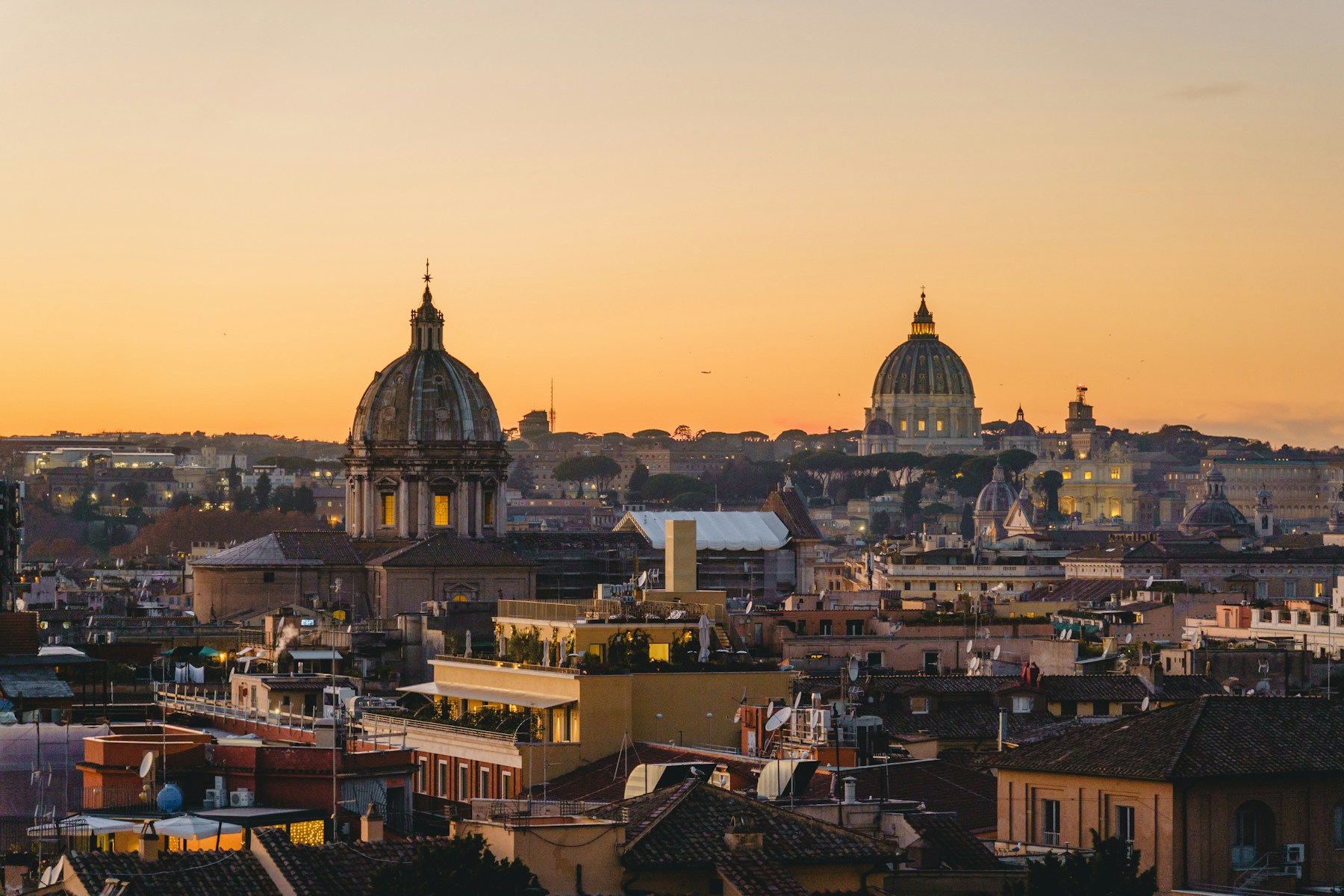 Rome skyline at sunset from Piazza Venezia with domes and rooftops