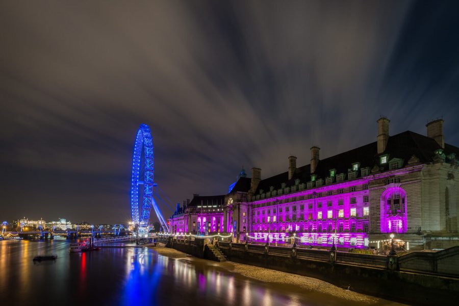 London Eye and illuminated County Hall reflected in the River Thames at night