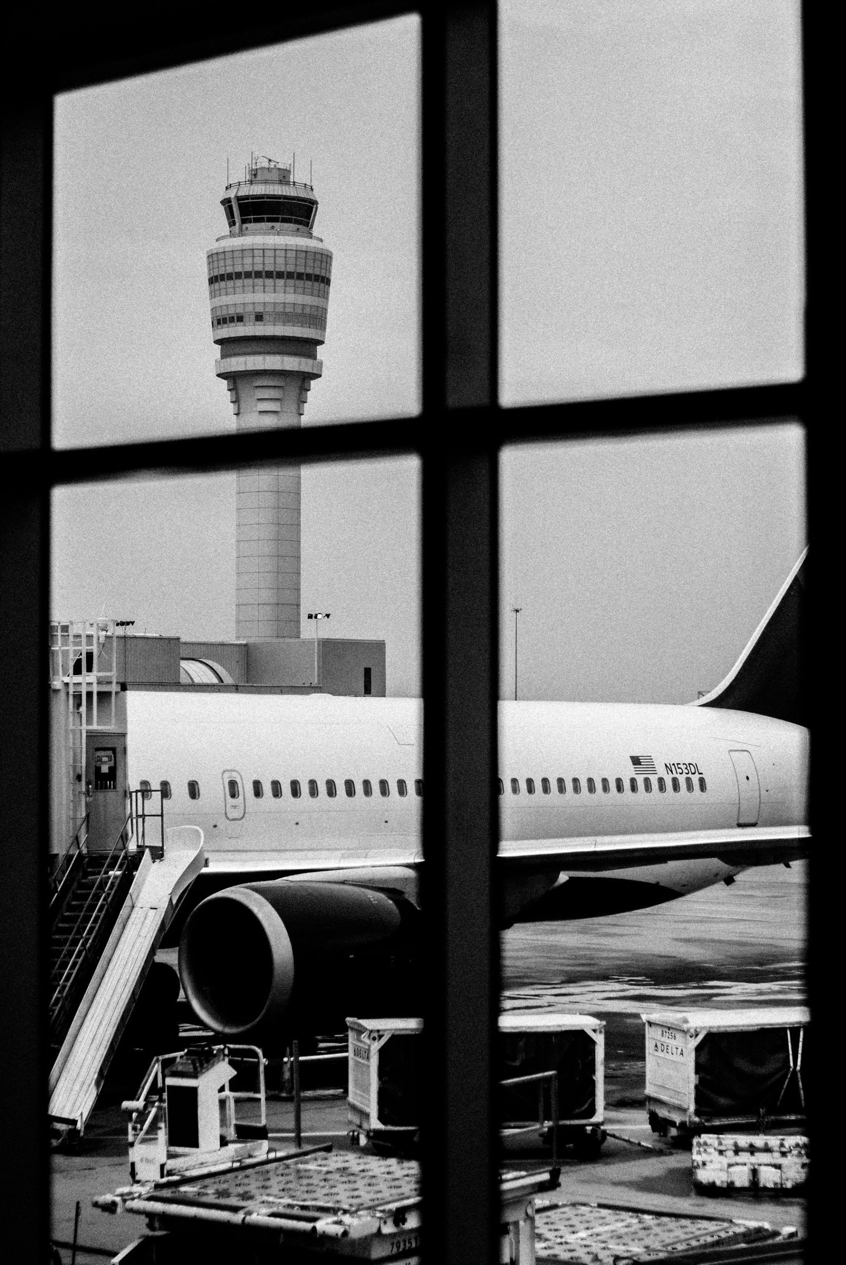 Delta aircraft and control tower viewed through Atlanta airport windows