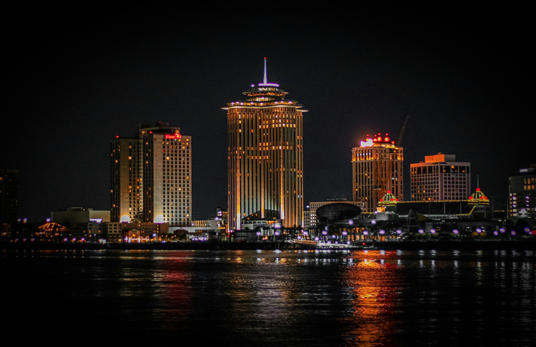 New Orleans skyline reflected in the Mississippi River at night