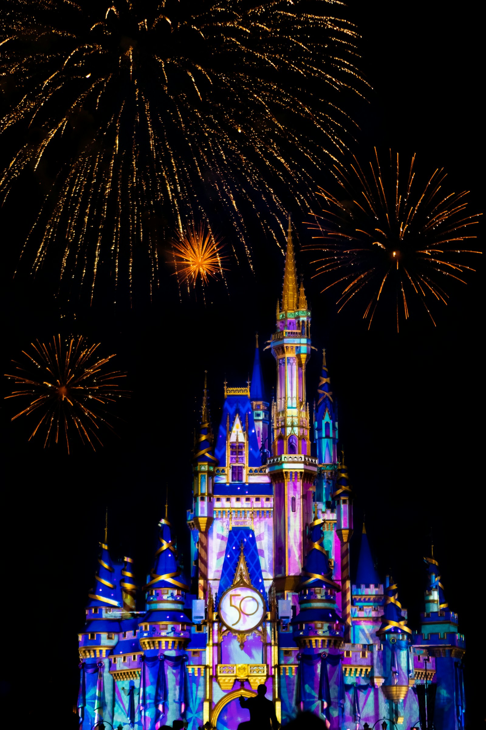 Cinderella Castle illuminated beneath fireworks at Magic Kingdom