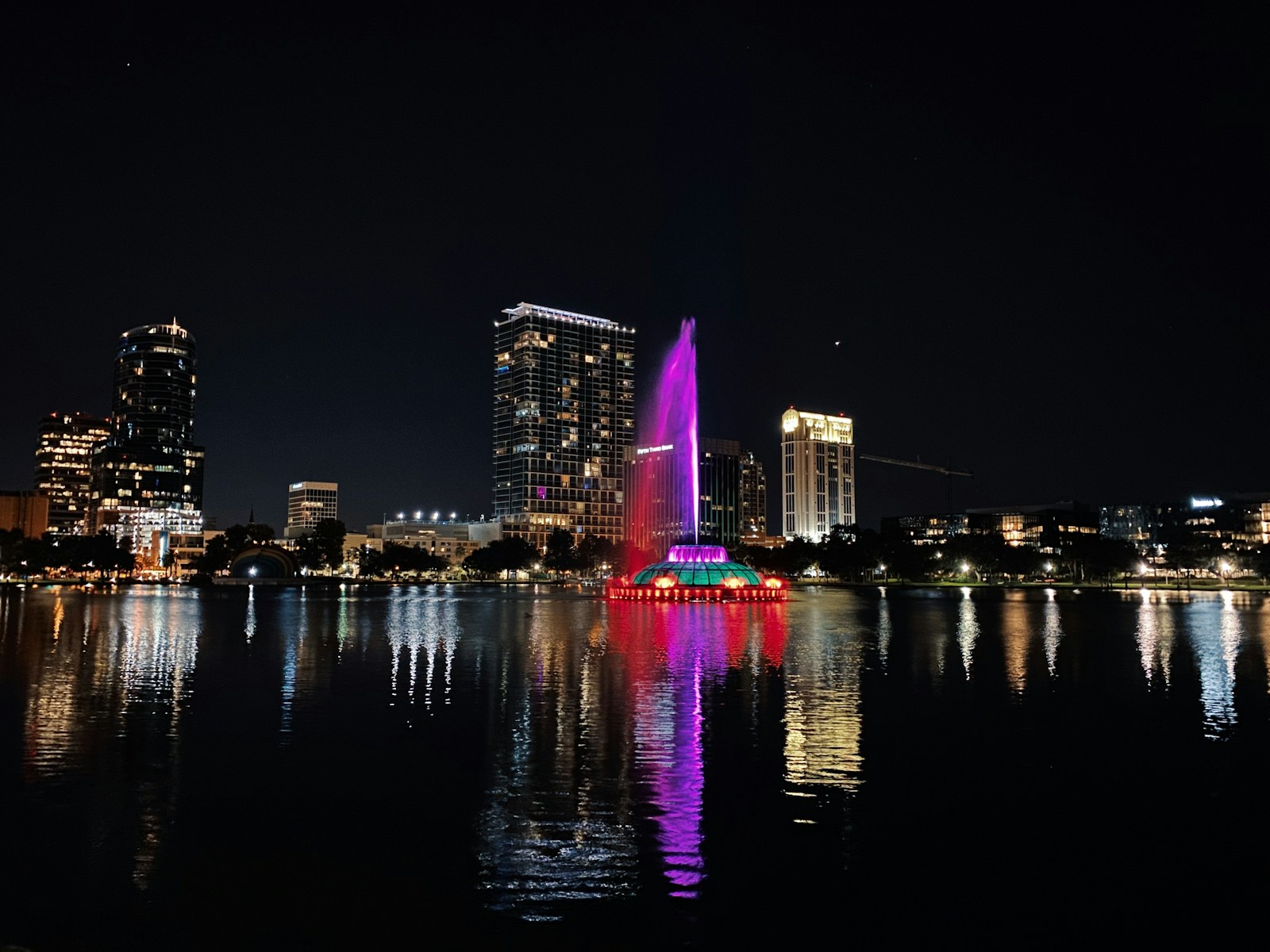 Downtown Orlando and Lake Eola fountain reflected at night