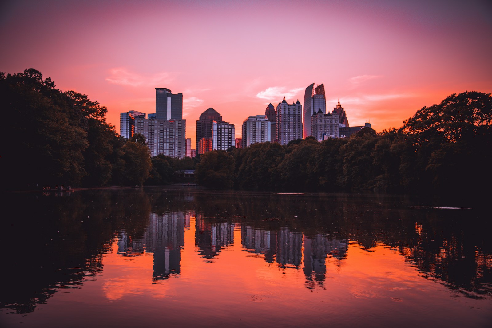 Atlanta Midtown skyline reflected in Piedmont Park lake at sunset