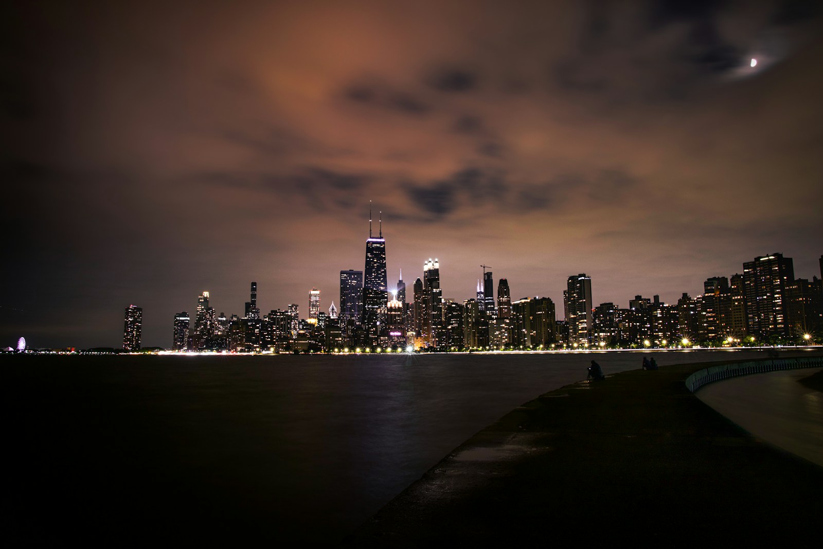 Chicago skyline illuminated above the lake at night