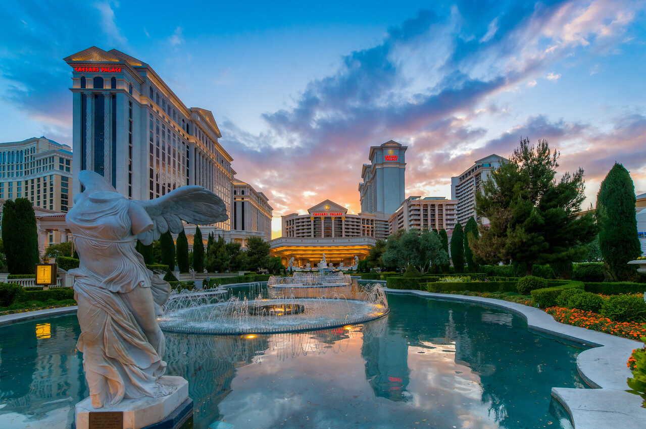 Caesars Palace fountain and architecture beneath pink-blue dusk sky