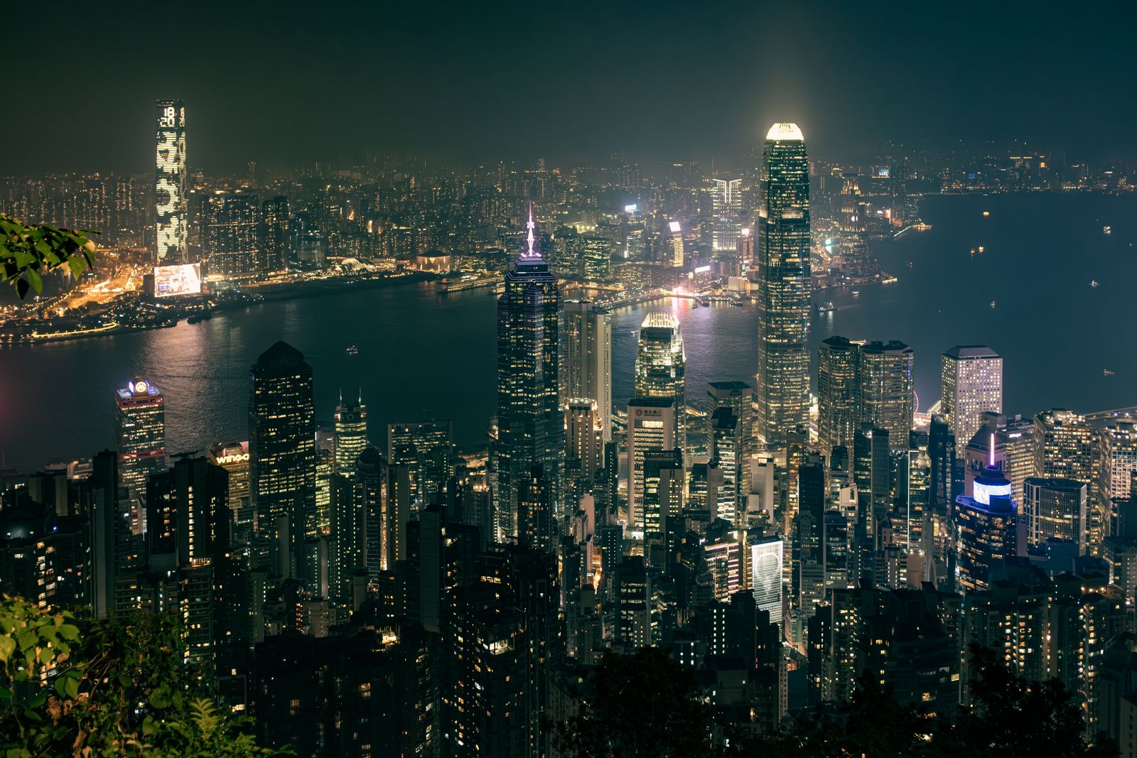 Hong Kong skyline and Victoria Harbour illuminated after dark from a high vantage point