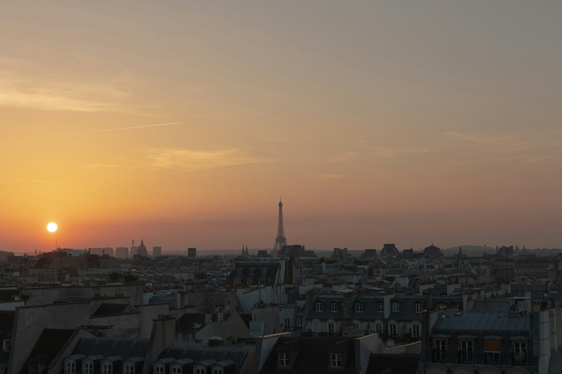 Eiffel Tower over Paris rooftops at golden sunset from Centre Pompidou
