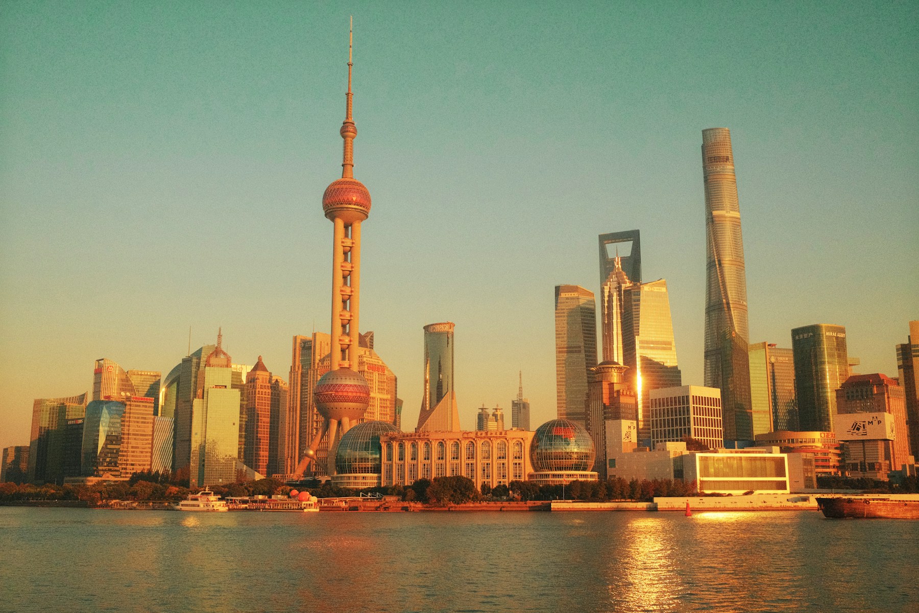 Lujiazui skyline across Huangpu River in warm sunset light