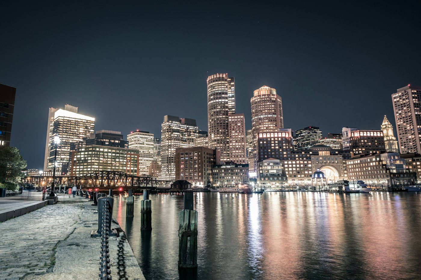 Boston waterfront skyline and harbor reflections at night