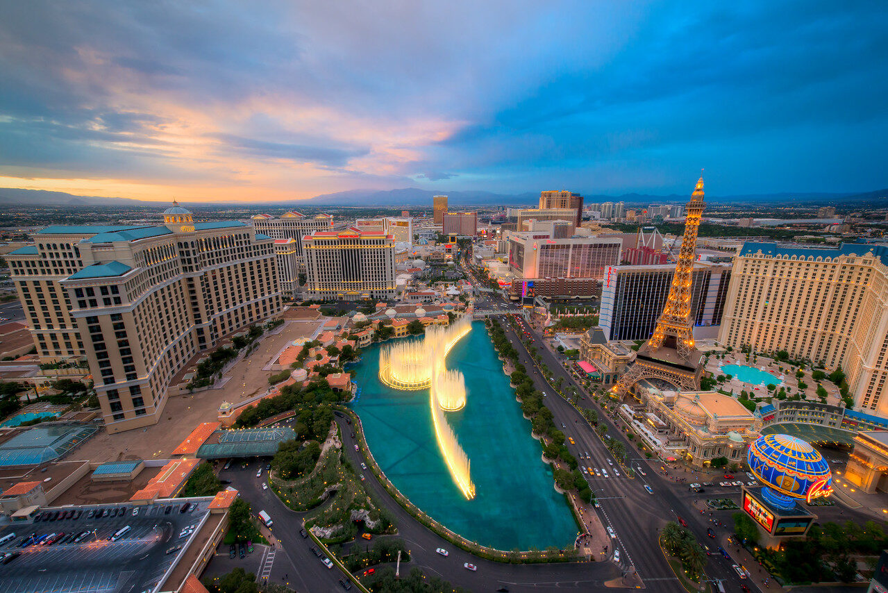 Bellagio fountain and Las Vegas Strip from above under blue-pink sunset