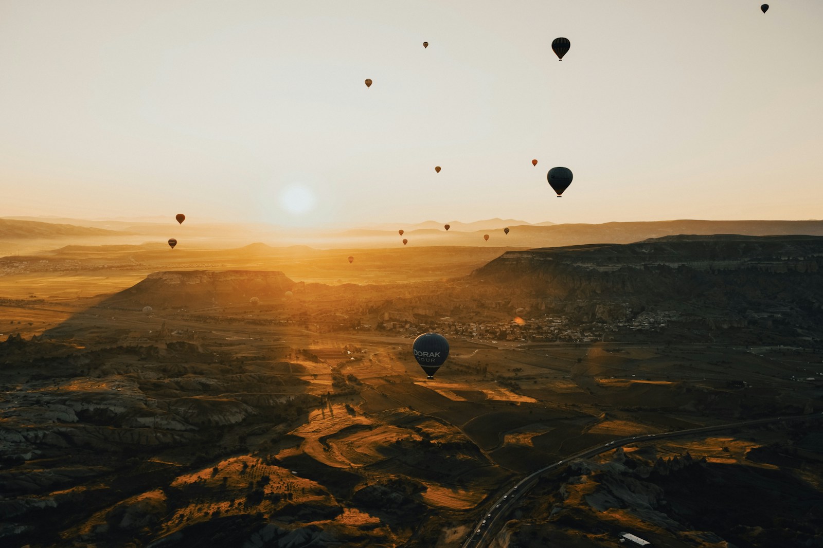 Hot air balloons over Cappadocia at golden hour